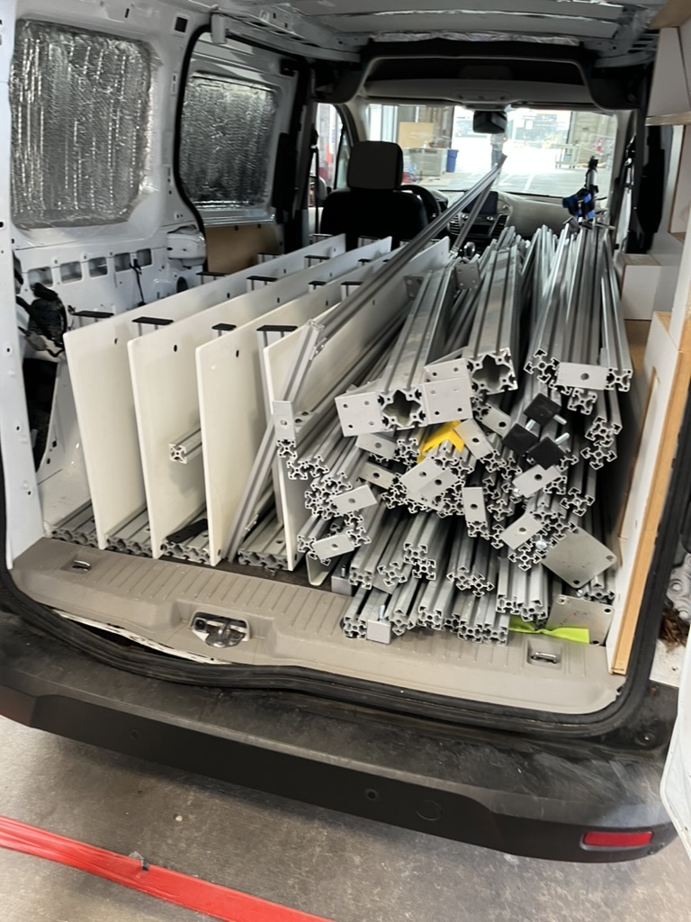 The van cargo bay packed with profiles, brackets and hardware
