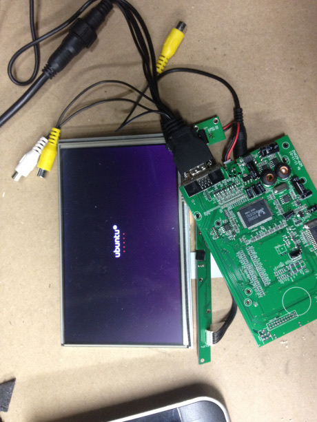 The bare LCD panel wired to its driver board, showing an Ubuntu boot screen