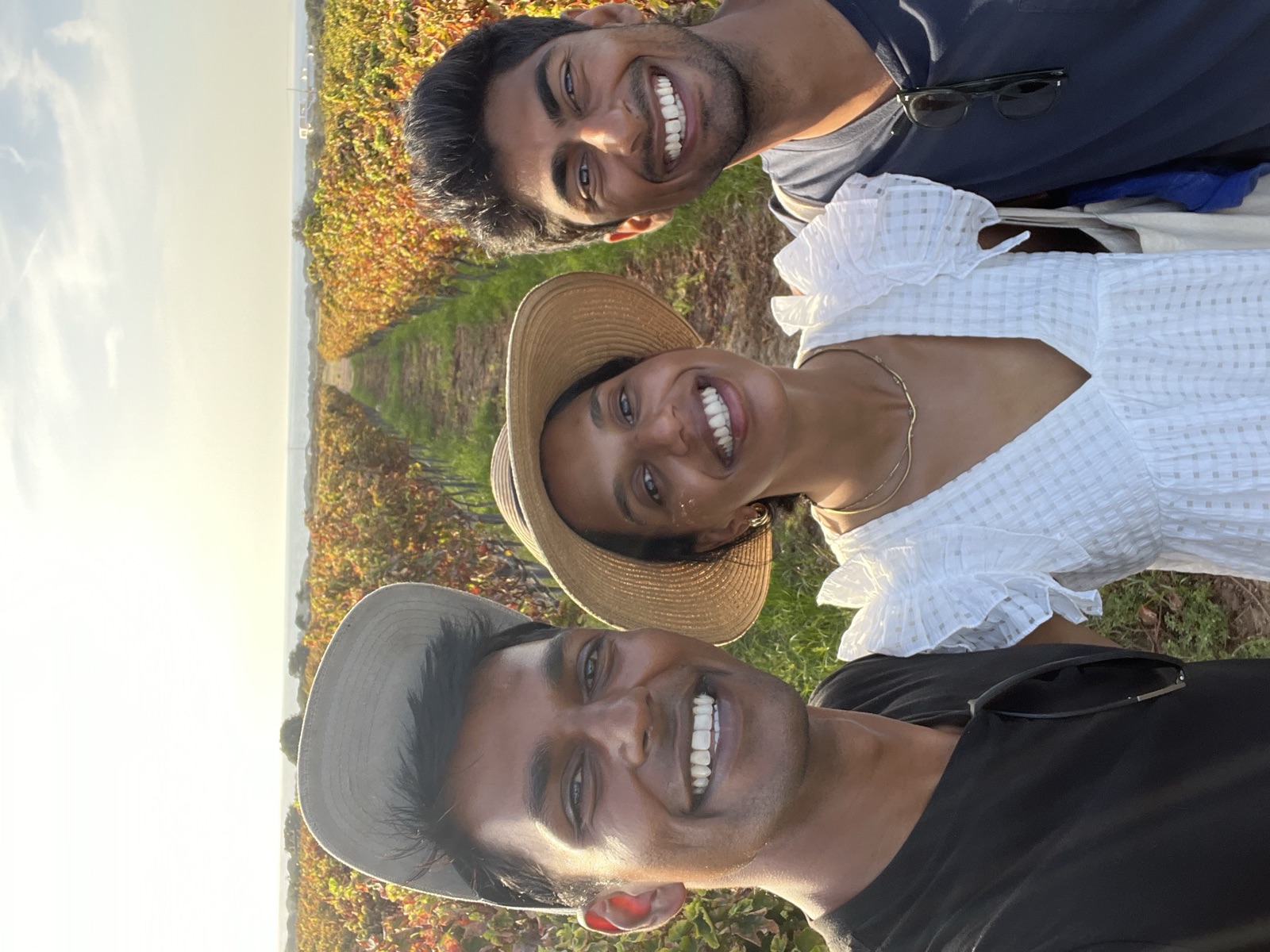 A selfie with Akhil and Jyo on a path through a vineyard