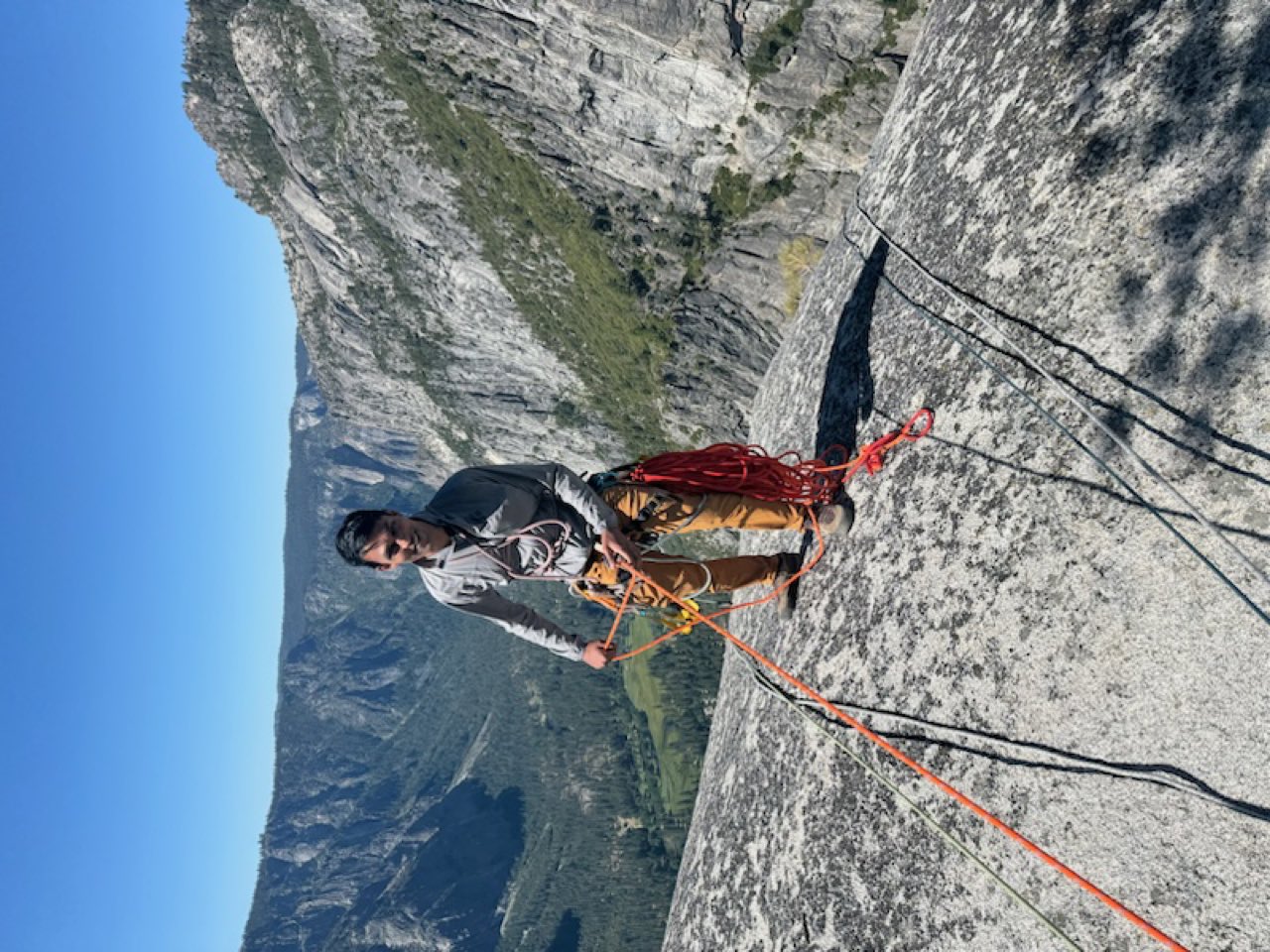 A portaledge hanging off a big wall route, with haul bags below