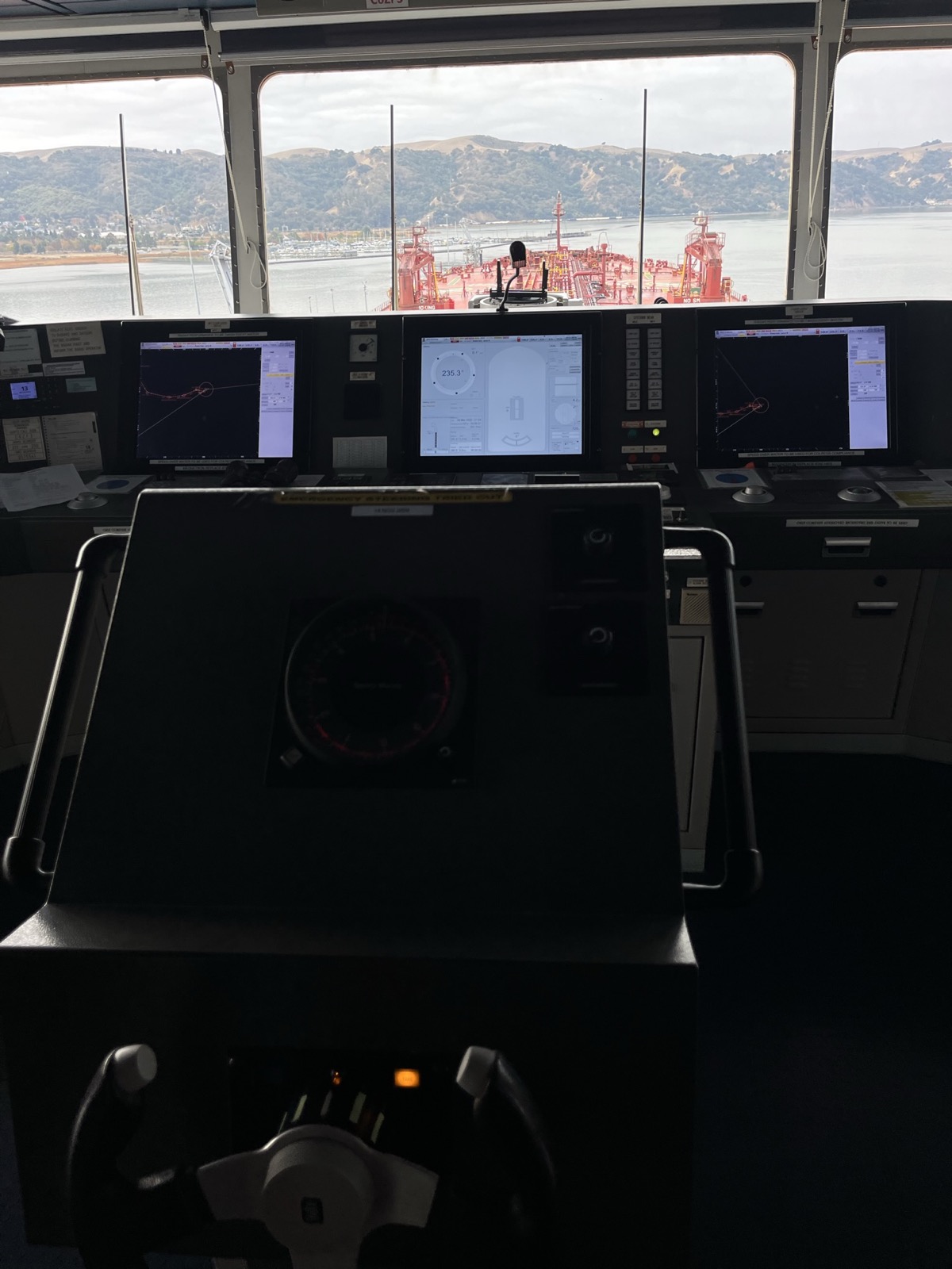The bridge of a tanker, with navigation consoles and the deck visible through the windows