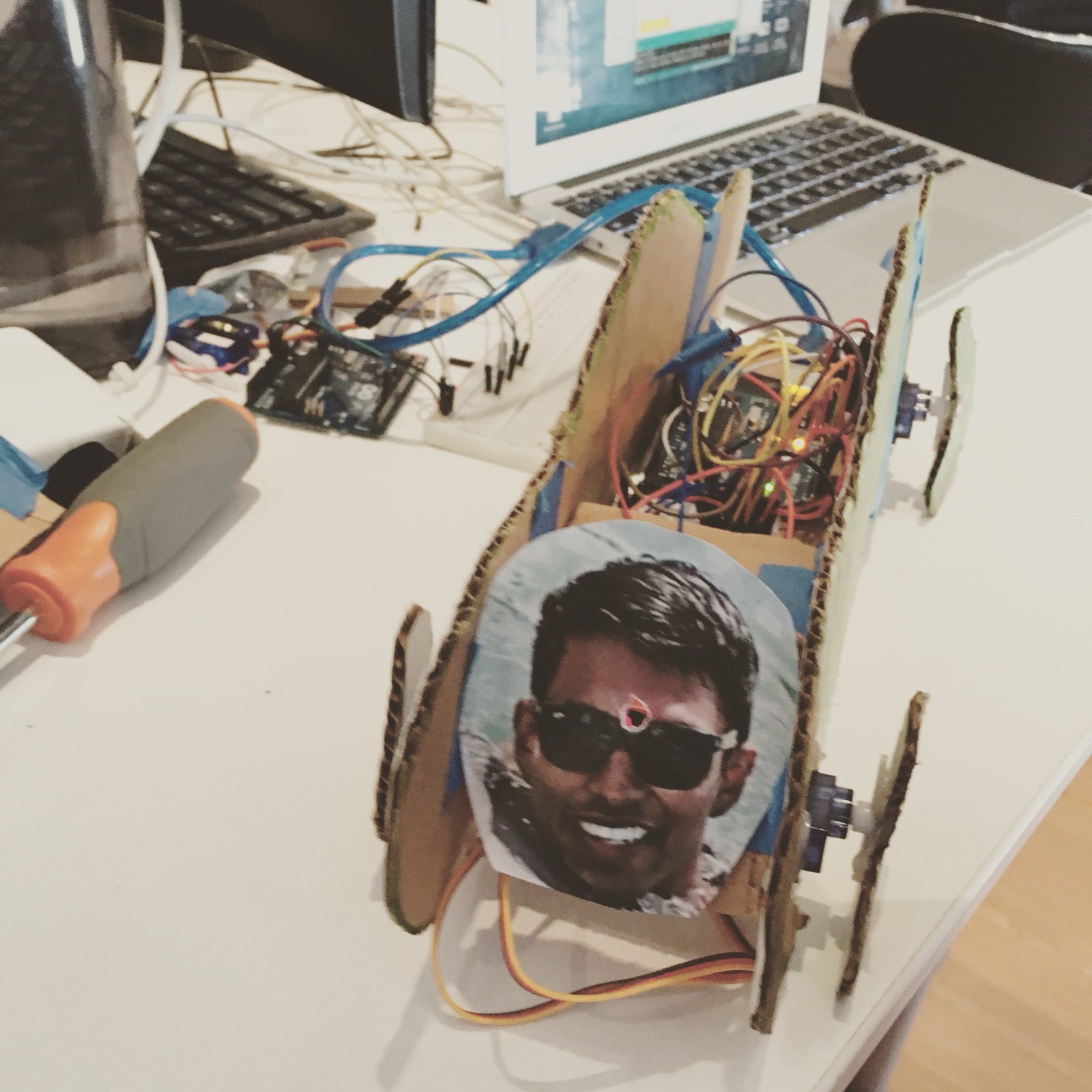 A cardboard car with an Arduino for an engine and a cutout of my face on the front