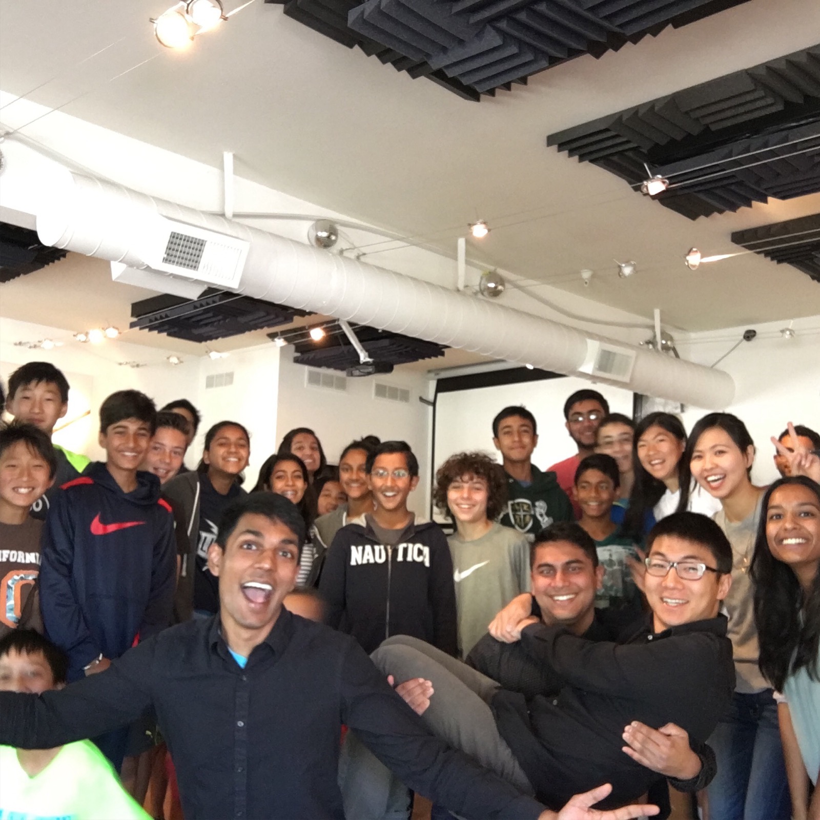 A crowd of students and instructors in a group photo inside the TechLab classroom